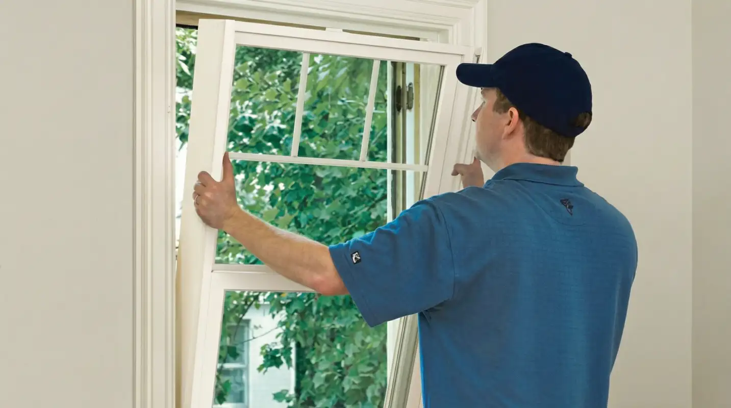 Professional contractors performing a residential window insulation and replacement service in New Haven, CT